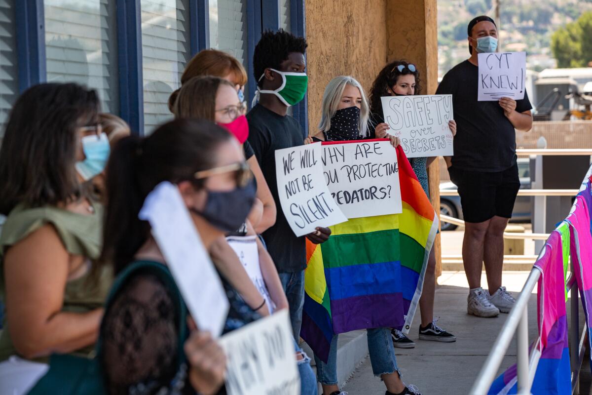 Protesters gathered outside Christian Youth Theater in El Cajon on Friday after a press conference by the theater's president