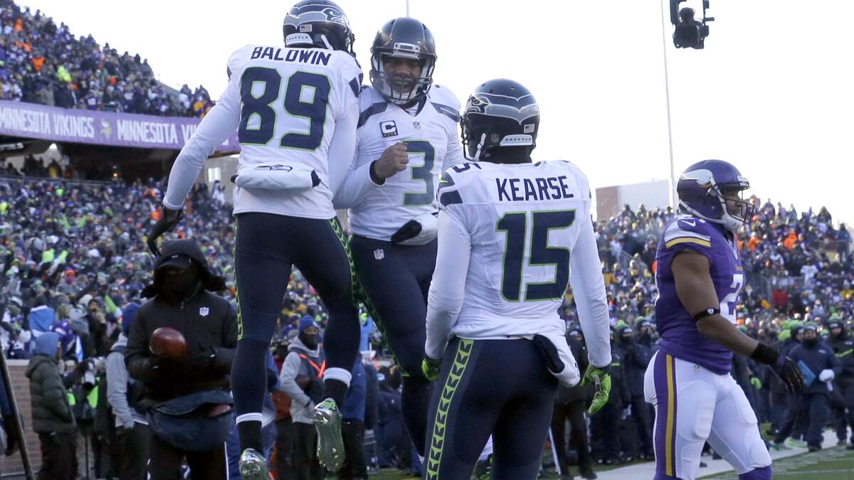 Seahawks wide receiver Doug Baldwin (89) and quarterback Russell Wilson (3) celebrate after connecting for a touchdown against the Vikings in the fourth quarter Sunday.