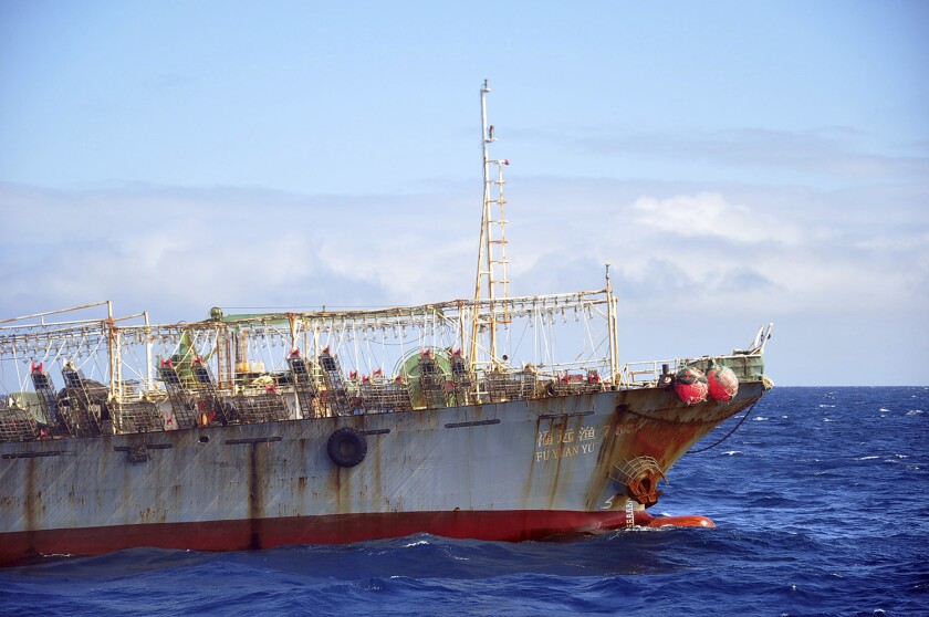 FILE - The Chinese squid fishing vessel Fu Yuan Yu 7880 sails on the Pacific Ocean, July 18, 2021. The Pingtan-affiliated vessel was arrested by South Africa in 2016 after it tried to flee a naval patrol that suspected it of illegal squid fishing. The ship's officers were found guilty of possessing illegal gear and disobeying a maritime authority but were released after paying a fine. (AP Photo/Joshua Goodman, File)