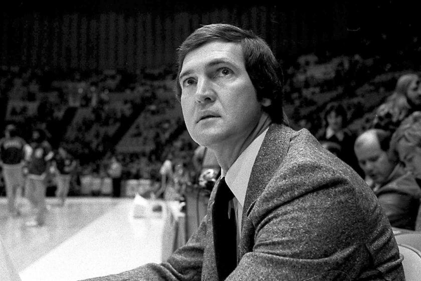 Jerry West, who was then the Lakers coach, sits on the sideline during a game in 1977. 