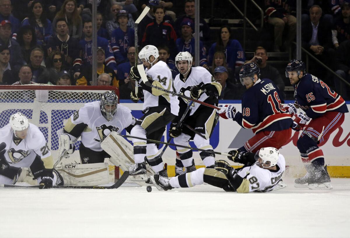 Penguins center Sidney Crosby (87) uses his body to block a shot in front of Rangers defenseman Marc Staal (18) in the first period on Mar. 13.