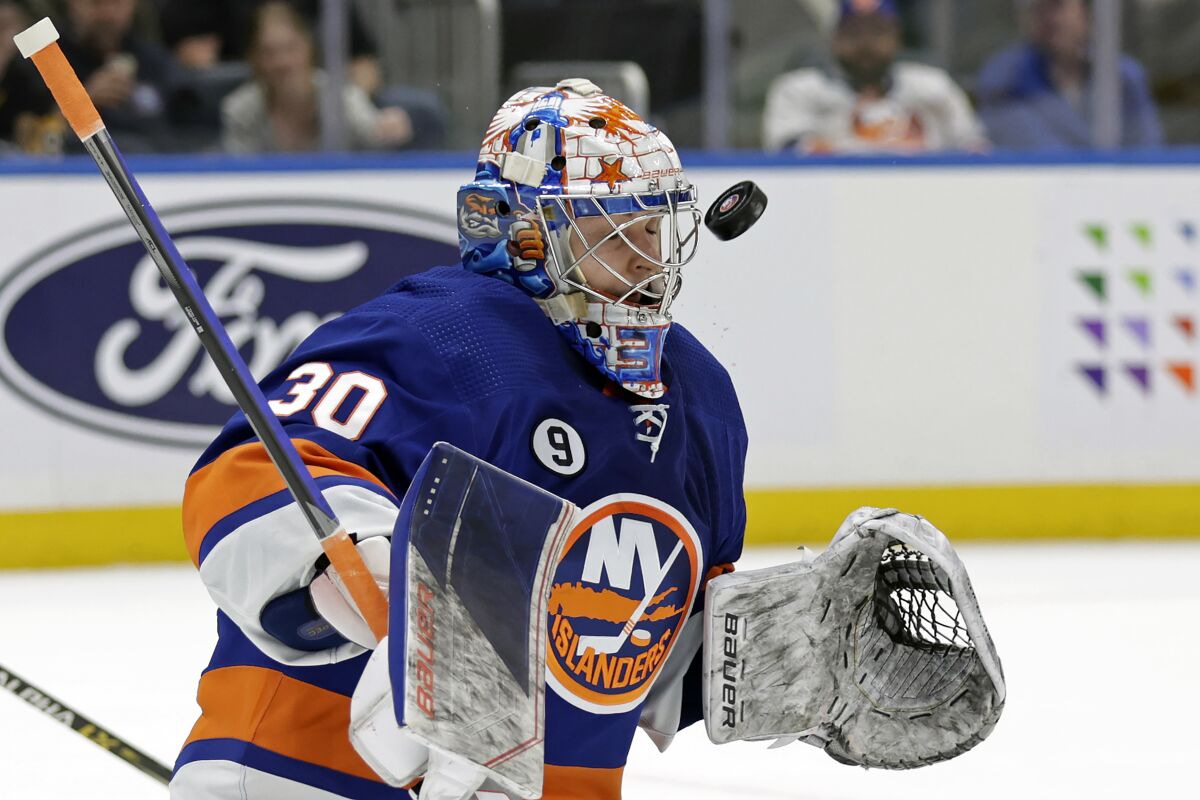 New York Islanders goaltender Ilya Sorokin makes a save in the first period of an NHL hockey game against the Pittsburgh Penguins, Tuesday, April 12, 2022, in Elmont, N.Y. (AP Photo/Adam Hunger)