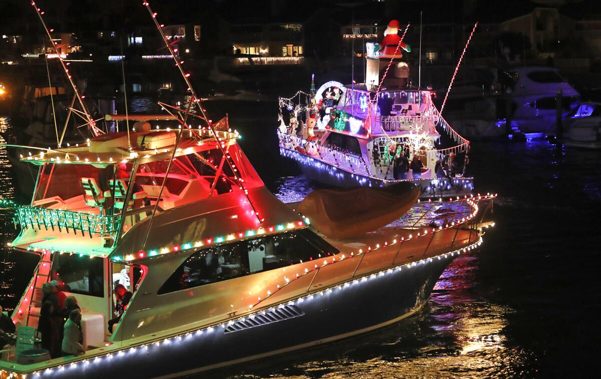 Vessels playing Christmas music make a turn at the Balboa Bridge.