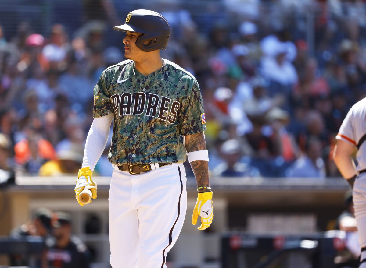 Padres designated hitter Manny Machado walks off after striking out.