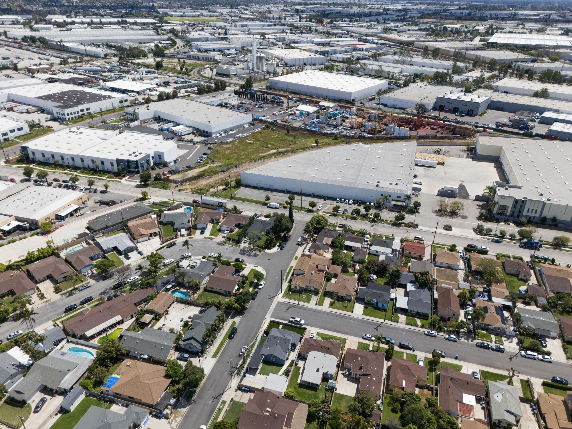 The homes in the foreground in this aerial image are near industrial businesses, including a hazardous waste processing facility.