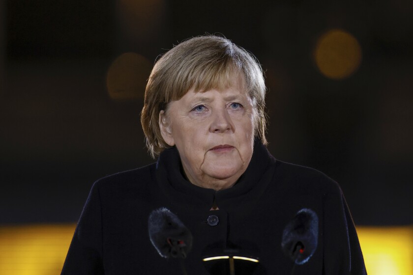German Chancellor Angela Merkel makes a speech at the Defence Ministry during the Grand Tattoo (Grosser Zapfenstreich), a ceremonial send-off for her, in Berlin on Thursday, Dec. 2, 2021. (Odd Andersen/Pool Photo via AP)