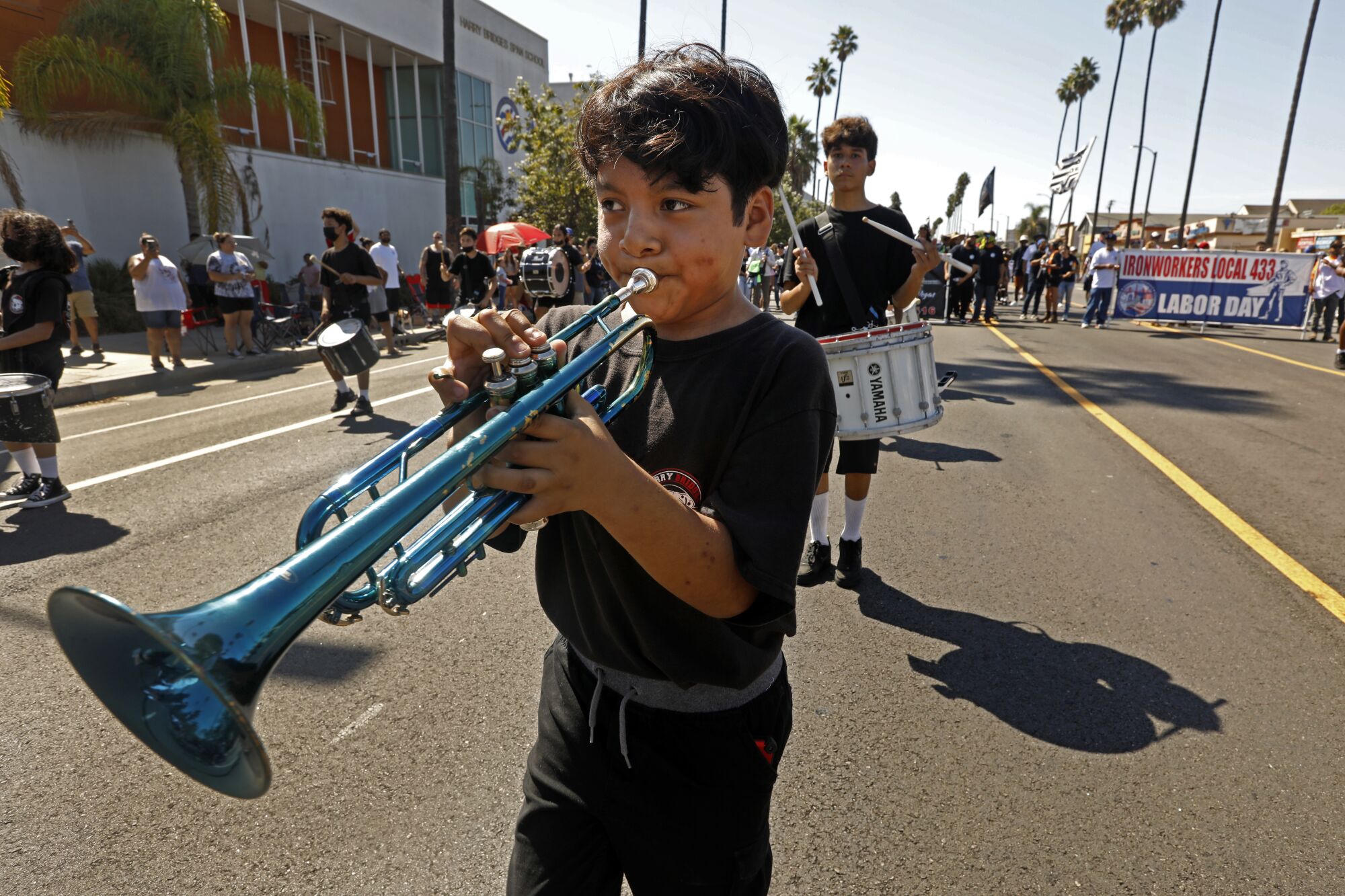 Carlos De Jesus plays a trumpet in a parade