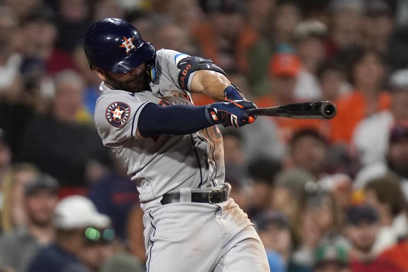 Houston Astros' Jose Altuve hits a two-run triple in the sixth inning of a baseball game.