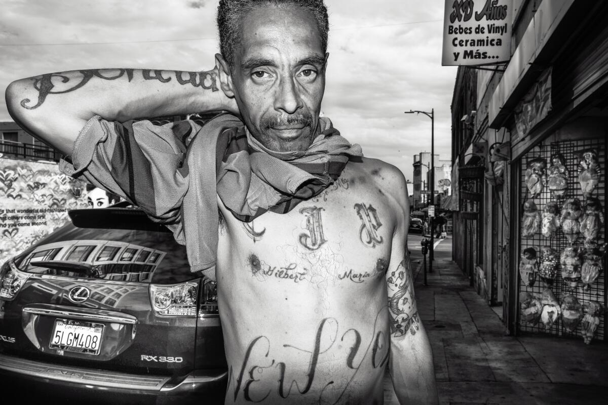 Rico. I ran into Rico and his dog, Bandit, on Winston Street. We began talking about his life, and I began taking his picture....he showed me the tattoos he received while in prison.