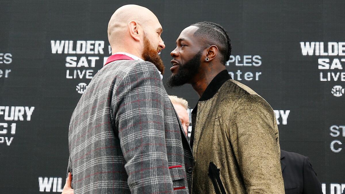 Tyson Fury, left, and Deontay Wilder face off during a news conference on Oct. 2 in New York City.