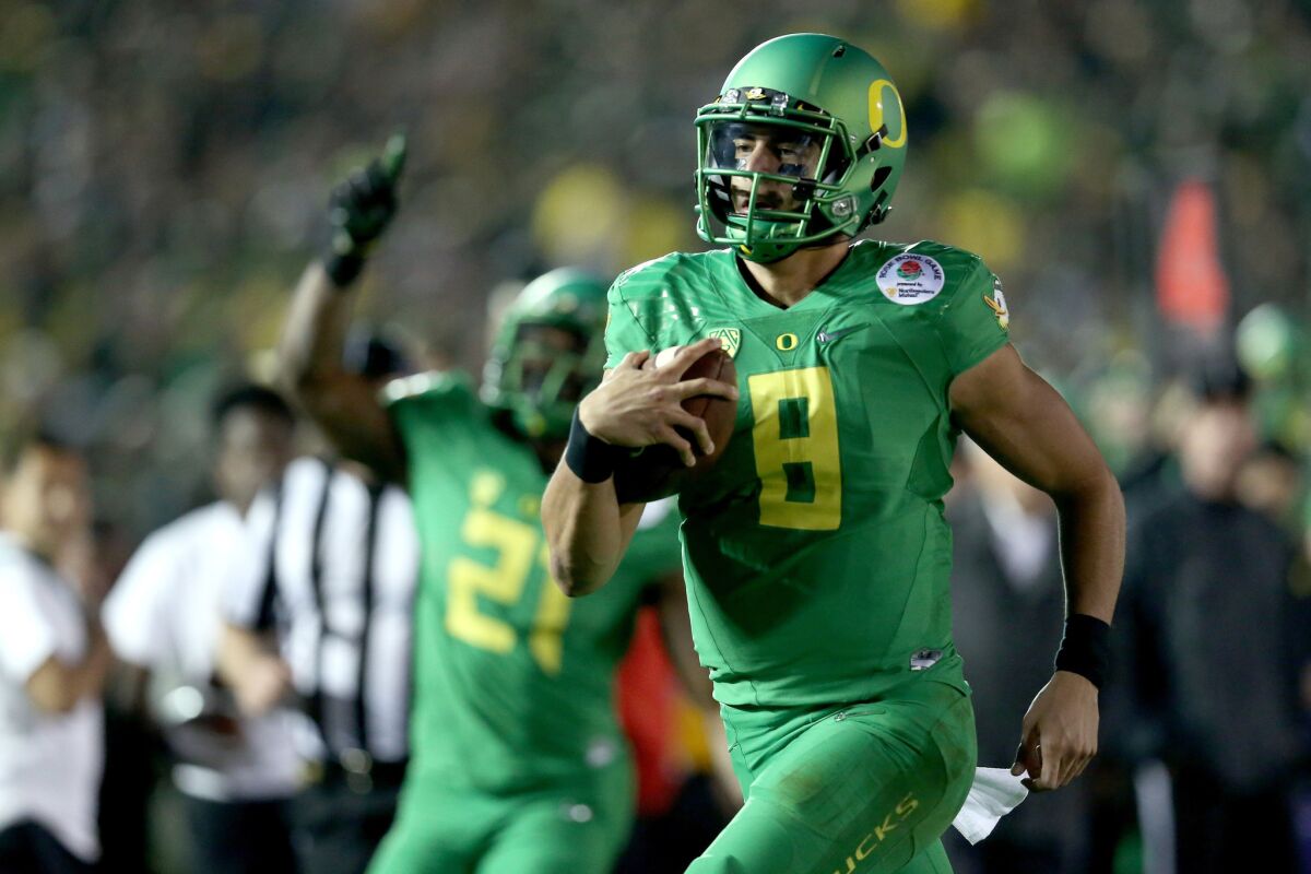 Oregon quarterback Marcus Mariota runs for a 23-yard touchdown against Florida State during the College Football Playoff semifinal game at the Rose Bowl on Jan. 1.