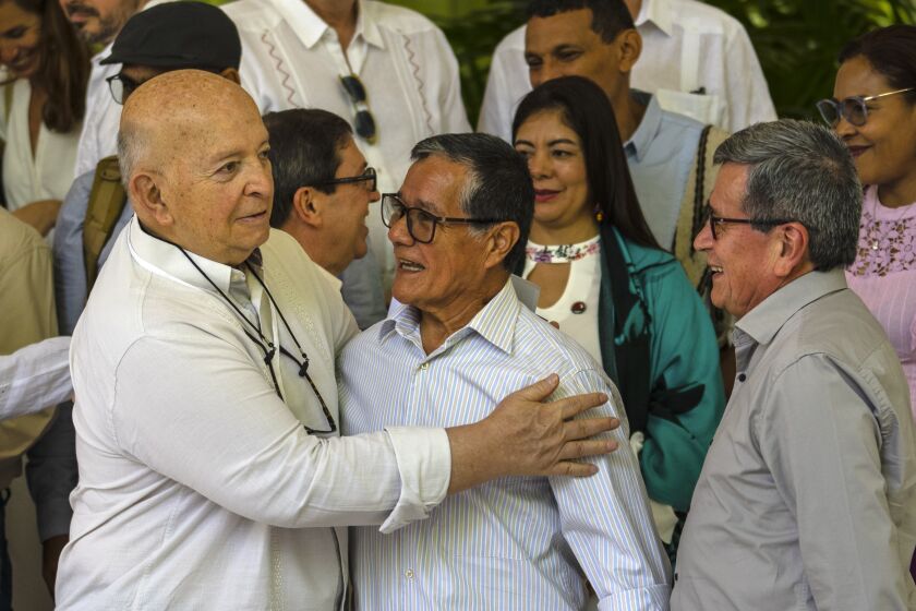 Jose Otty Patiño, chief negotiator for the Colombian government, left, Nicolás Rodríguez Bautista alias "Gabino," former commander of the Colombian National Liberation Army (ELN), center, and ELN Commander Pablo Beltran gather for a group photo at the inauguration of the third cycle of peace negotiations between the ELN and the Colombian government in Havana, Cuba, Tuesday, May 2, 2023. (AP Photo/Ramon Espinosa)