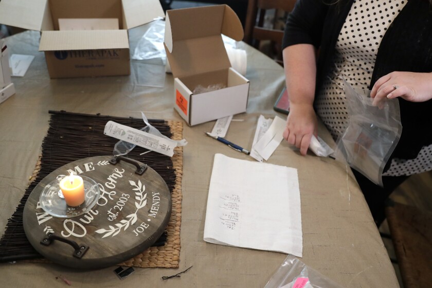 Mendy McNulty gathers test swabs together for shipment