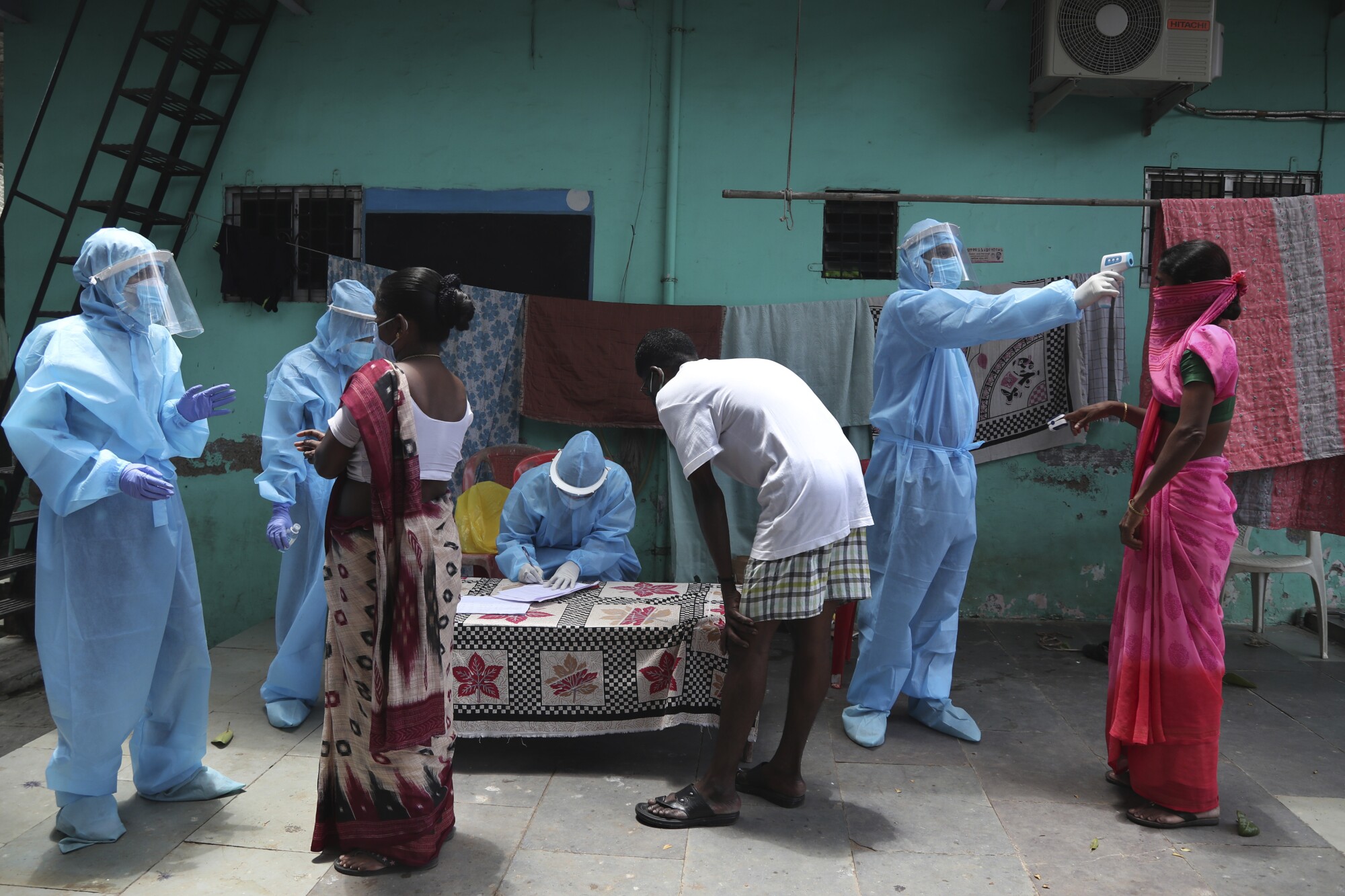 Doctors conduct a free medical camp in Dharavi, a slum in Mumbai, India.