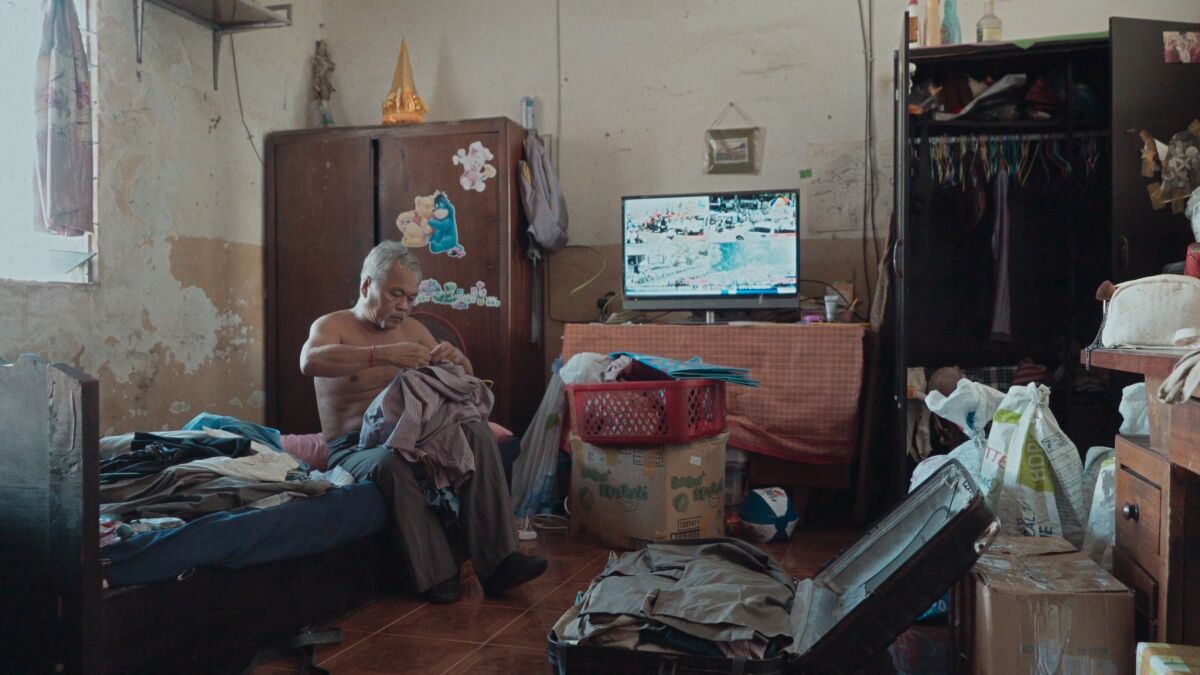 A still from the 2019 documentary “Last Night I Saw You Smiling,” which director Kavich Neang filmed inside a historic apartment building in Phnom Penh, Cambodia, before it was demolished.