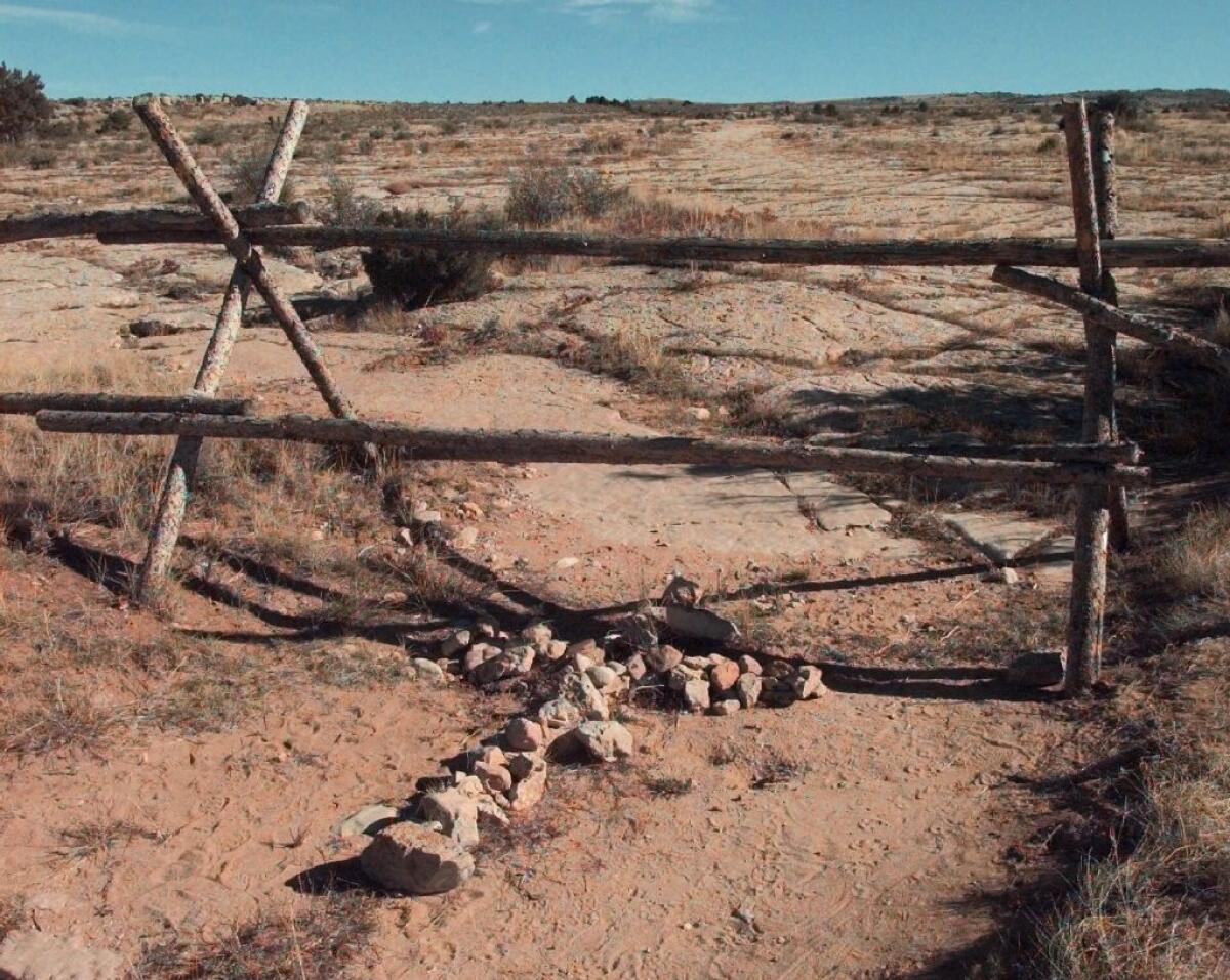 A cross made of stones rests below the fence in Laramie, Wyo., where University of Wyoming student Matthew Shepard was beaten to death.
