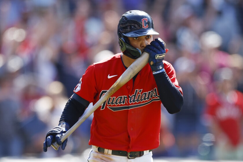 Cleveland Guardians' Andres Gimenez kisses his bat after hitting a game-winning, two-run home run against the Minnesota Twins during the ninth inning of a baseball game Thursday, June 30, 2022, in Cleveland. (AP Photo/Ron Schwane)