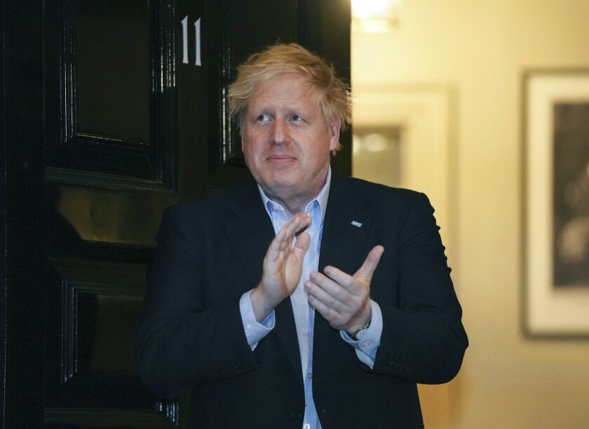 British Prime Minister Boris Johnson claps outside 11 Downing St. in London on April 2 in honor of healthcare workers fighting the coronavirus pandemic. Johnson was admitted to St. Thomas’ Hospital late Sunday, 10 days after he was diagnosed with COVID-19.