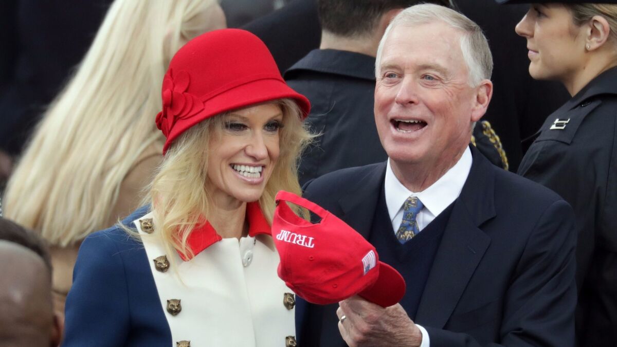 Kellyanne Conway, in Gucci, talks with former Vice President Dan Quayle on Inauguration Day.