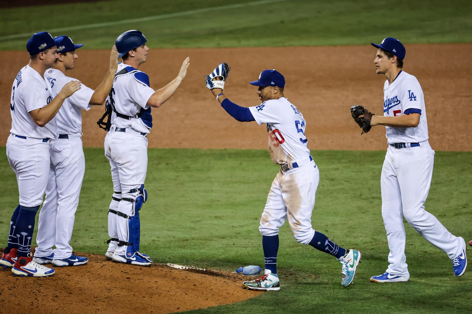 Dodgers players celebrate their 4-2 win over the Milwaukee Brewers in Game 1 on Wednesday.