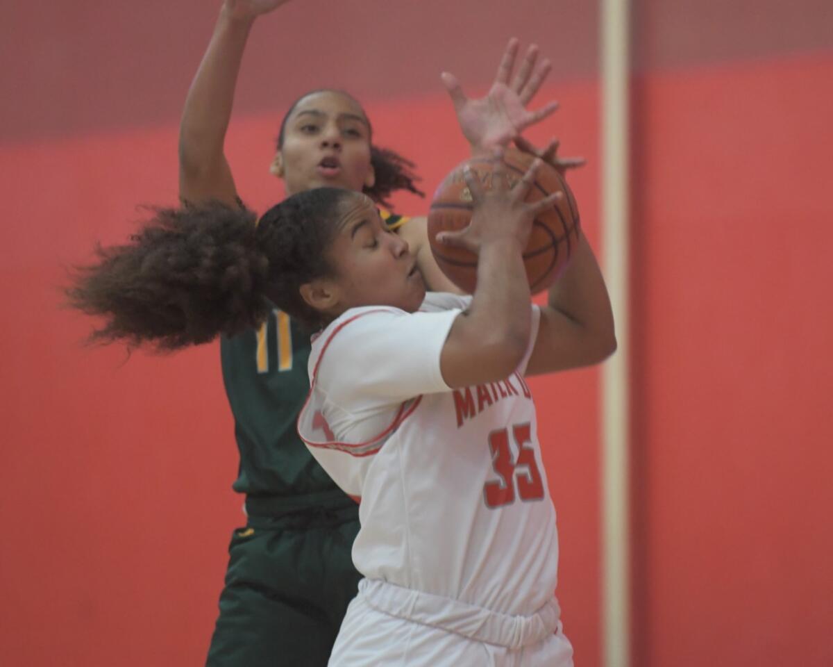 Caia Elisaldez of Mater Dei intercepts a pass against Long Beach Poly.