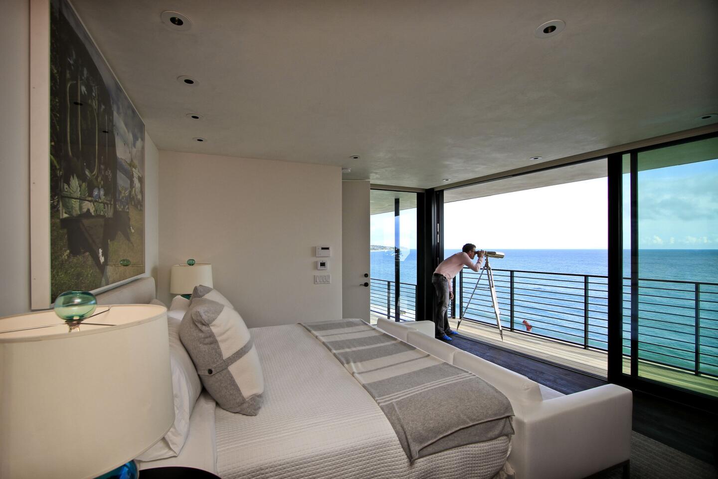 Floor-to-ceiling glass doors open the master bedroom to the coastline in this house by the firm W+D. Designer Brent Woods said one goal was to contain and manage foot traffic, preserving privacy from room to room. Note how a few steps and a guardrail (out of view) subtly partition the master suite from the vast lounging deck beyond. Homeowner Mickey Liddell, a producer whose credits include the TV series "Everwood" and the Liam Neeson action film "The Grey," said weekend guests "can get up early in the morning and be in and out on that deck, and I don't even know it." Full gallery and 360-degree interactive panoramas