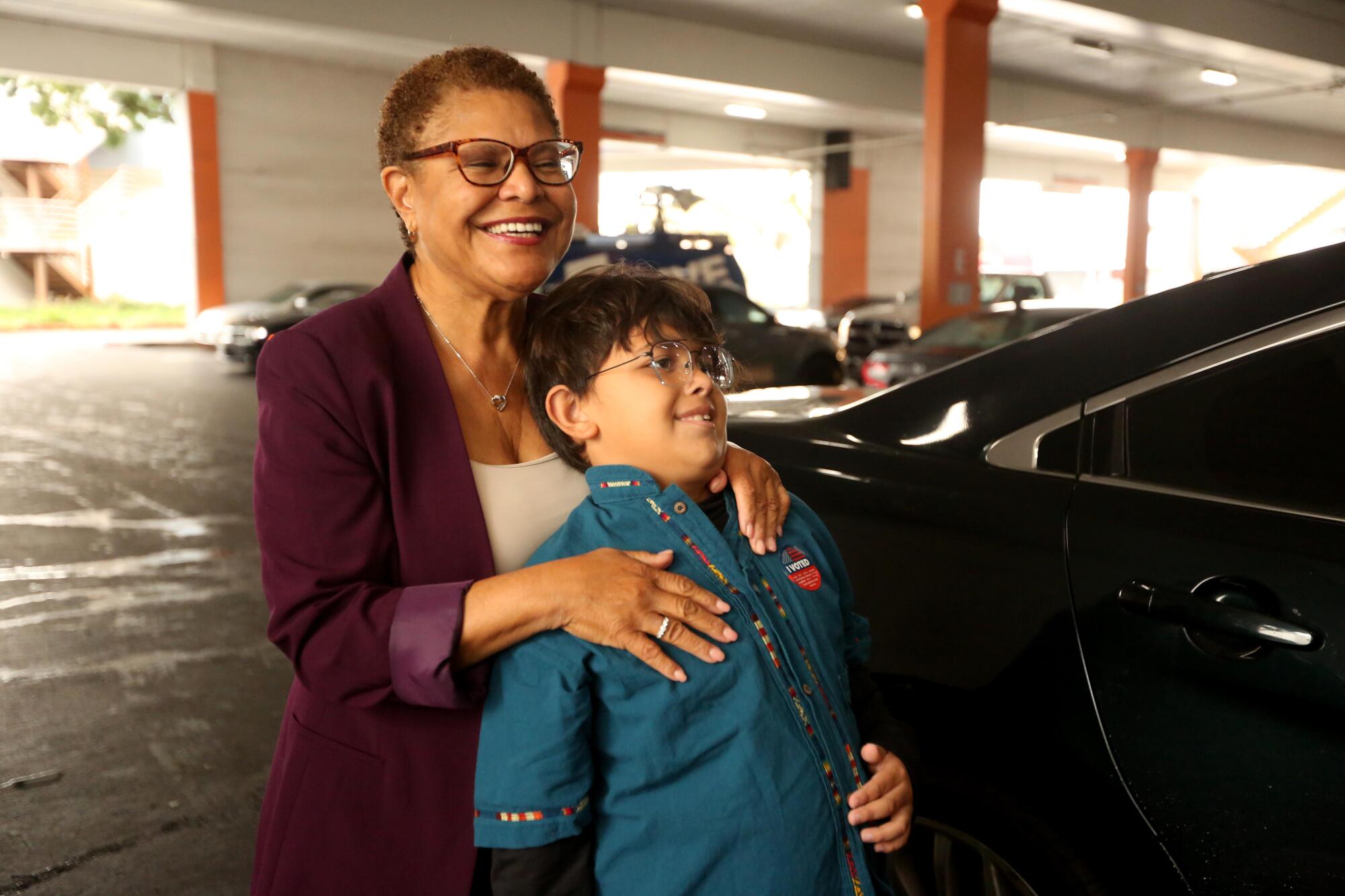 Rep. Karen Bass, with her grandson Henry, 8, votes at the Baldwin Hills Crenshaw Plaza.