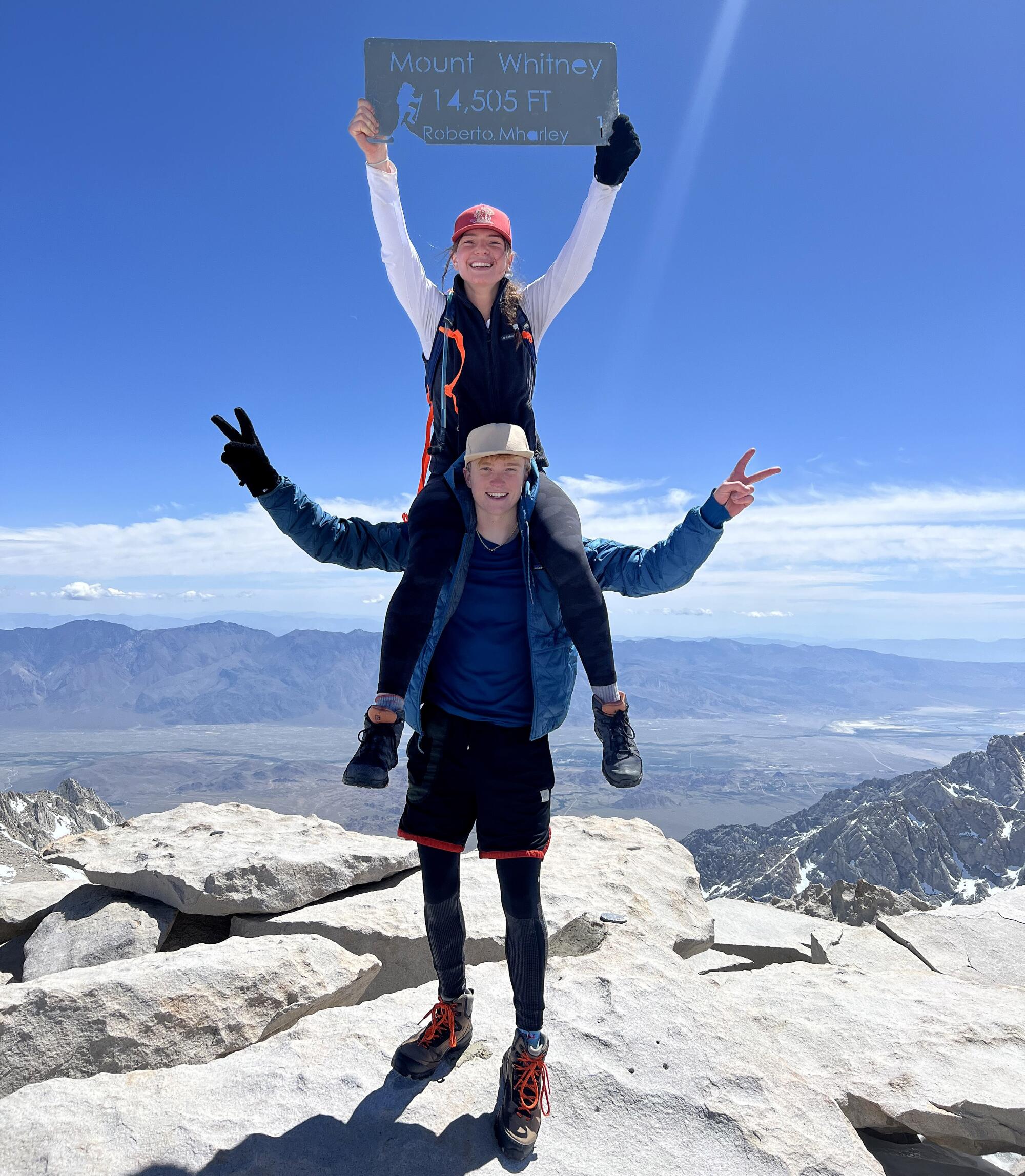 Carson Severson and Sofia Goodwin celebrate at the summit of Mt. Whitney.