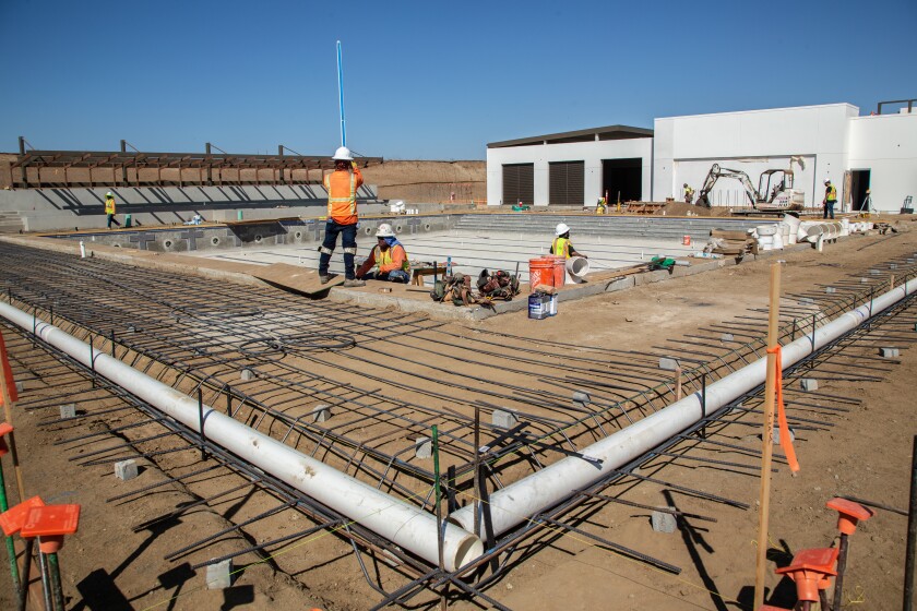 Workers prepare to pour concrete in October at the El Corazon Aquatics Center. The pool is now nearly finished.