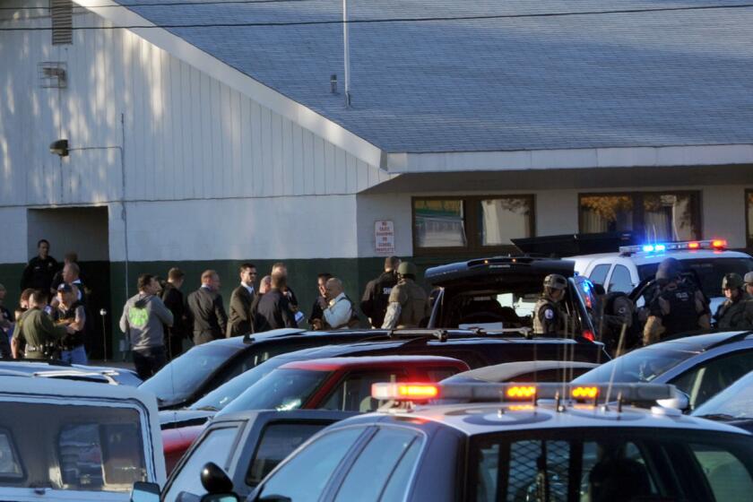 Law enforcement personnel gather at the scene of a shooting at Sparks Middle School in Sparks, Nev.