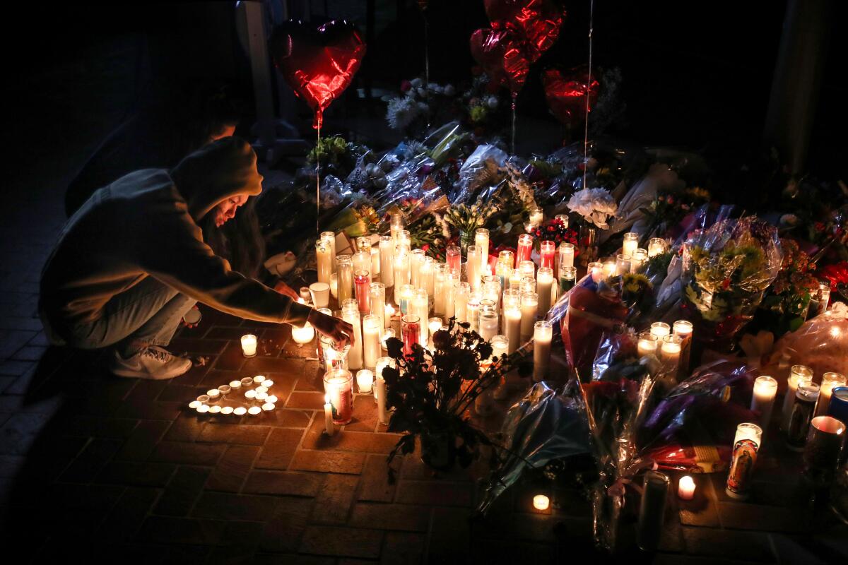Mourners take part in a vigil for the victims of a mass shooting at the Star Dance Studio.