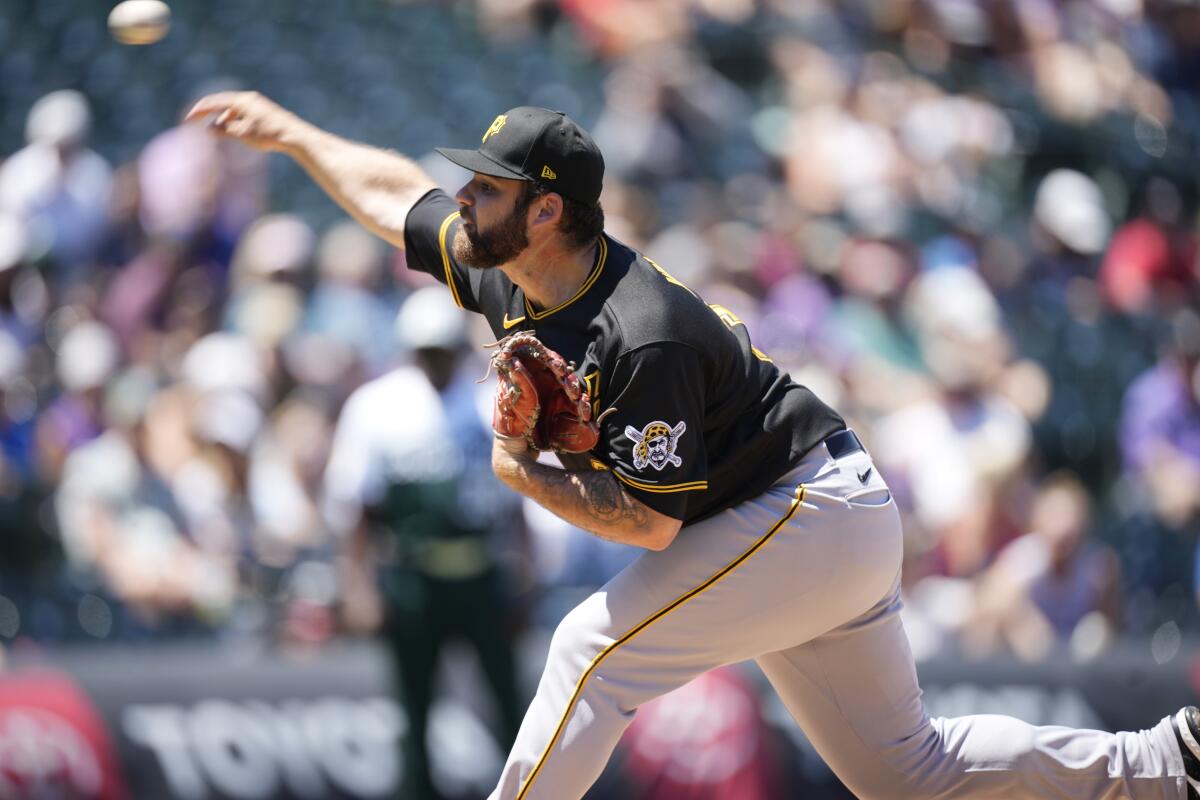 Pittsburgh Pirates starting pitcher Bryse Wilson works against the Colorado Rockies in the first inning of a baseball game, Sunday, July 17, 2022, in Denver. (AP Photo/David Zalubowski)