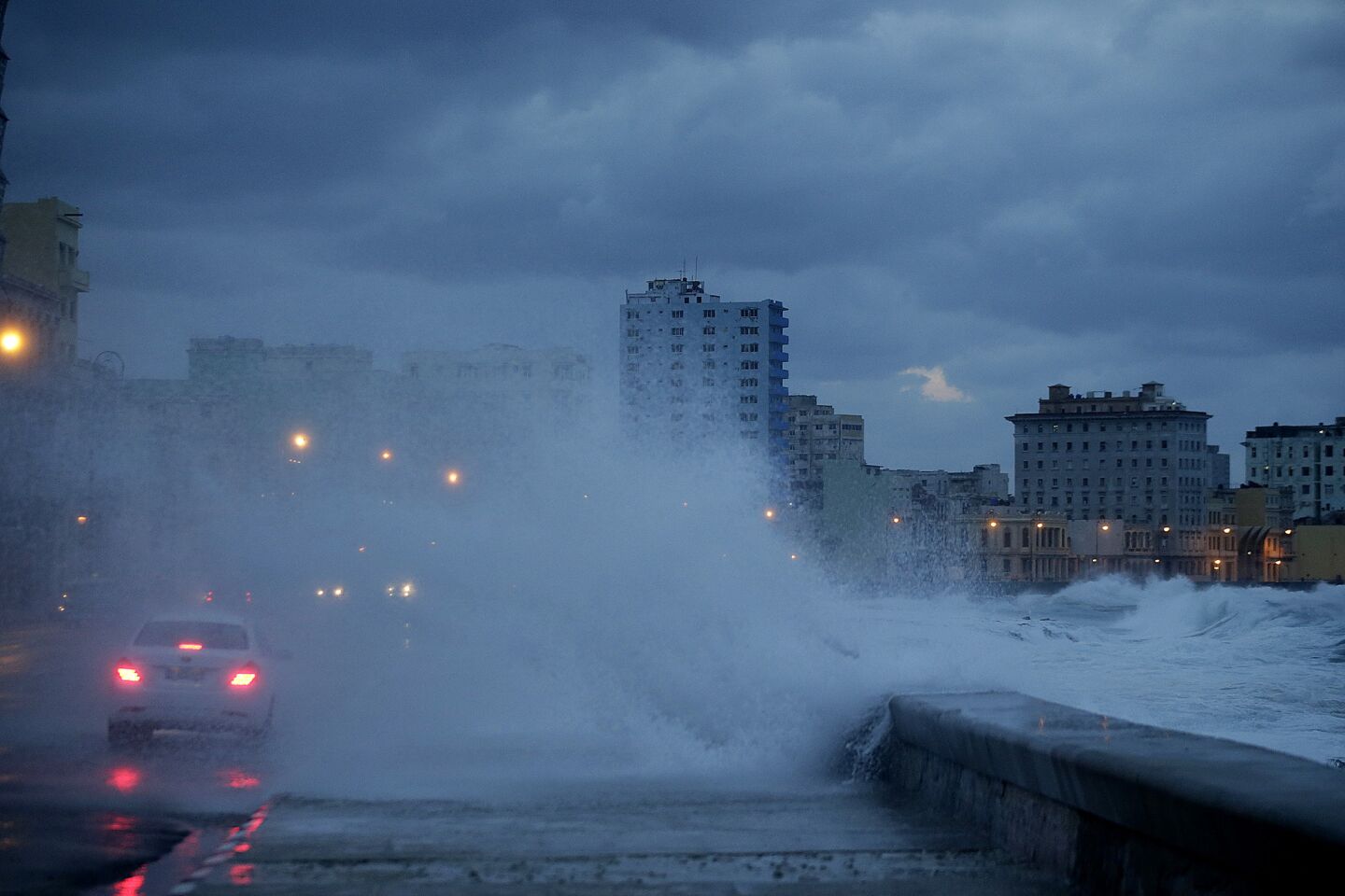 Waves crash well beyond the seawall along Havana's Malecon as a storm hangs over Cuba for a second straight day.