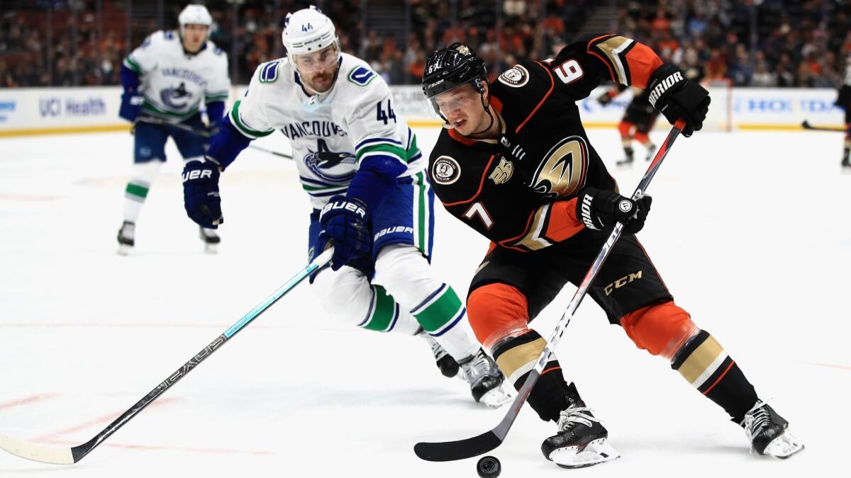 Rickard Rakell of the Ducks skates past Erik Gudbranson of the Vancouver Canucks during the third period.