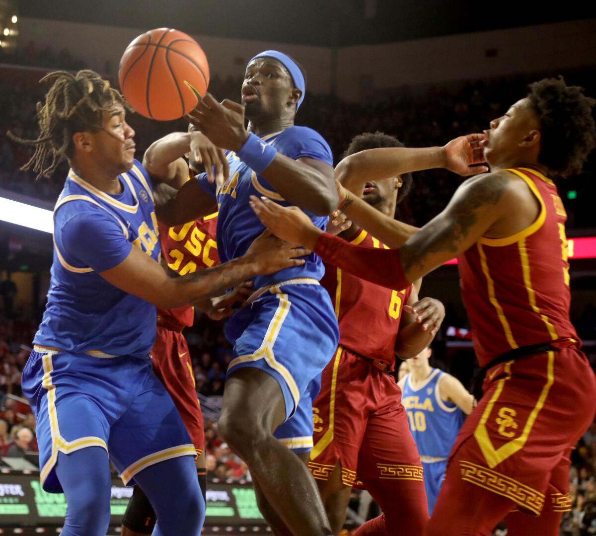UCLA's Adem Bona, center, loses control of a ball during the Bruins' 65-50 win over USC at Galen Center.