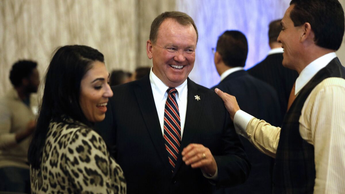 Sheriff Jim McDonnell, center, with Alexandra Kazarian and Felipe Plascencia on election night at the JW Marriott in Los Angeles.