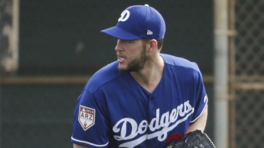 Los Angeles Dodgers' Clayton Kershaw makes a play during a spring training baseball workout Feb. 13 in Glendale, Ariz.
