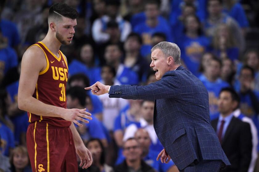 Southern California head coach Andy Enfield, right, yells at forward Nick Rakocevic during the first half of an NCAA college basketball game against UCLA Saturday, Jan. 11, 2020, in Los Angeles. (AP Photo/Mark J. Terrill)