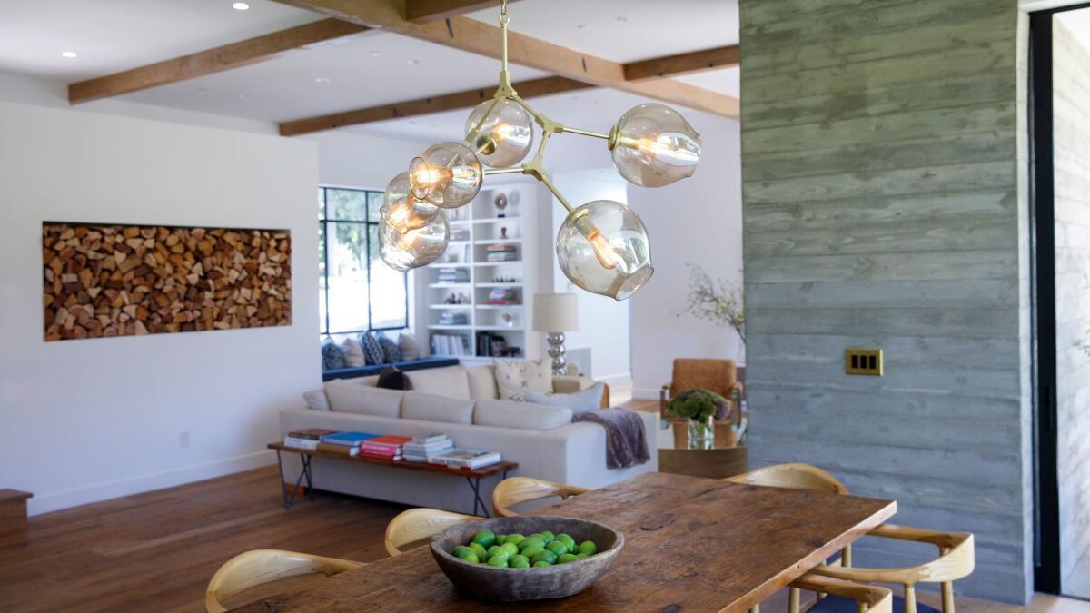 LOS ANGELES, CA--MAY 12, 2017--Rustic wide plank oak floors and hand-scraped Douglas-fir ceiling beams contrast with crisp white walls, with a dining room pendant by Lindsey Adelman, in the Studio City, CA., home of Jamie Klasfeld, photographed May 12, 2017. (Jay L. Clendenin / Los Angeles Times)