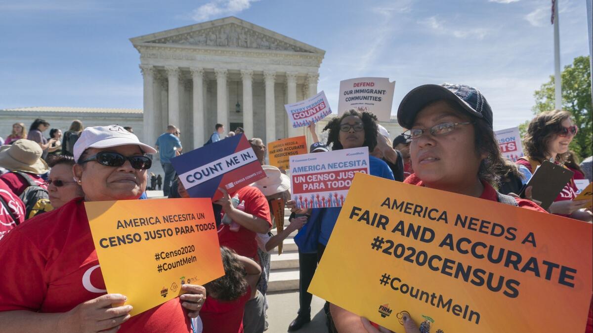 Immigration activists rally outside the Supreme Court in Washington on April 23 during arguments over the Trump administration's plan to ask about citizenship on the 2020 census.
