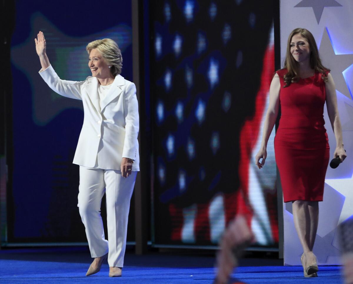 Democratic presidential nominee Hillary Clinton, who appears with daughter Chelsea Clinton, arrives to speak onstage during the final day of the Democratic National Convention at the Wells Fargo Center in Philadelphia.