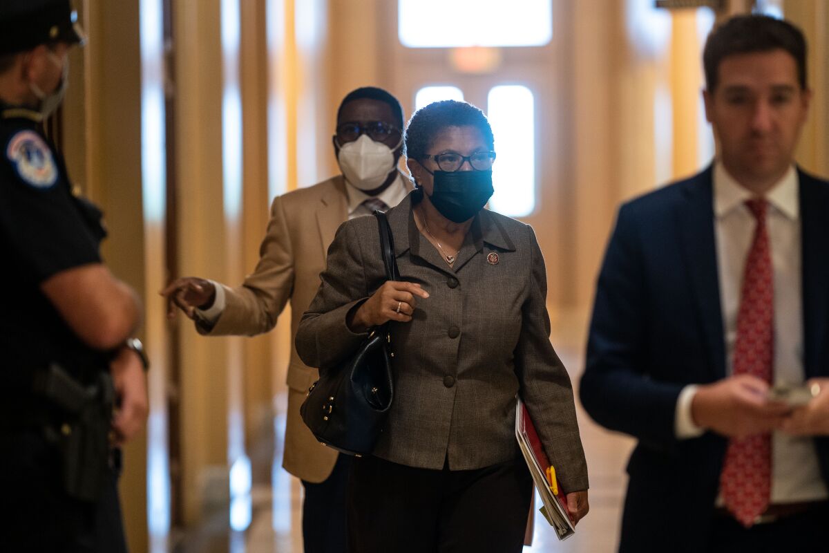 Karen Bass walks through a U.S. Capitol hallway.