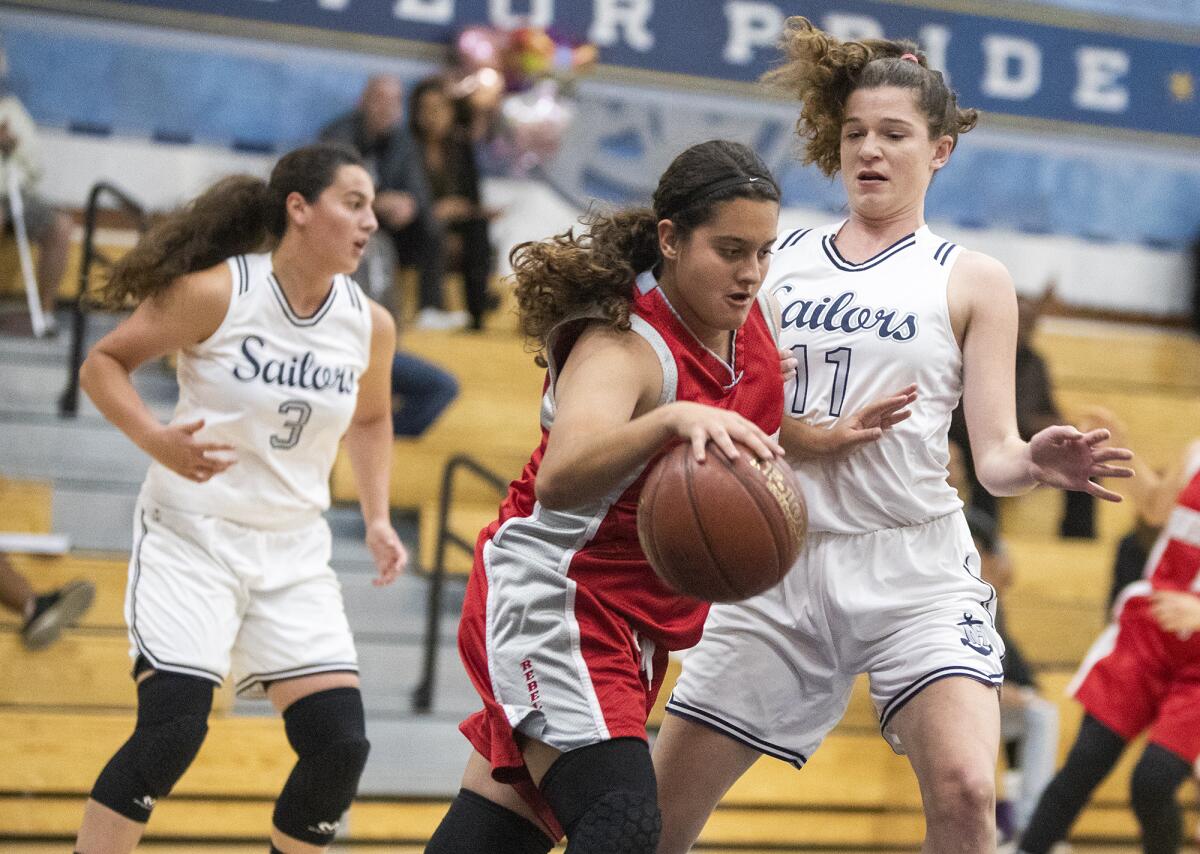 Newport Harbor's Chloe Swanson (11) pressures Savanna's Monique Nevarez during a nonleague game on Tuesday.