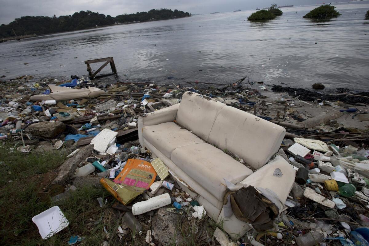 A discarded sofa litters the shore of Guanabara Bay in Rio de Janeiro on June 15.
