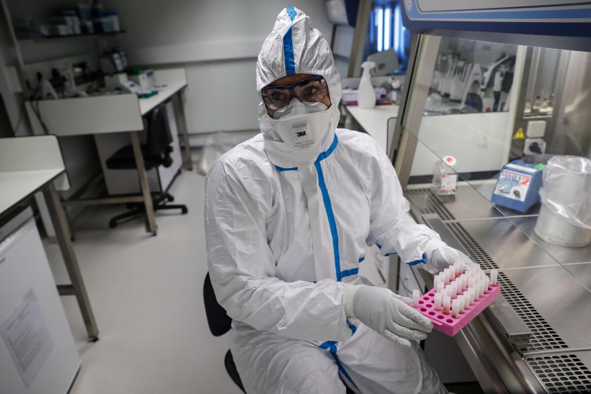 Laboratory worker in protective suit