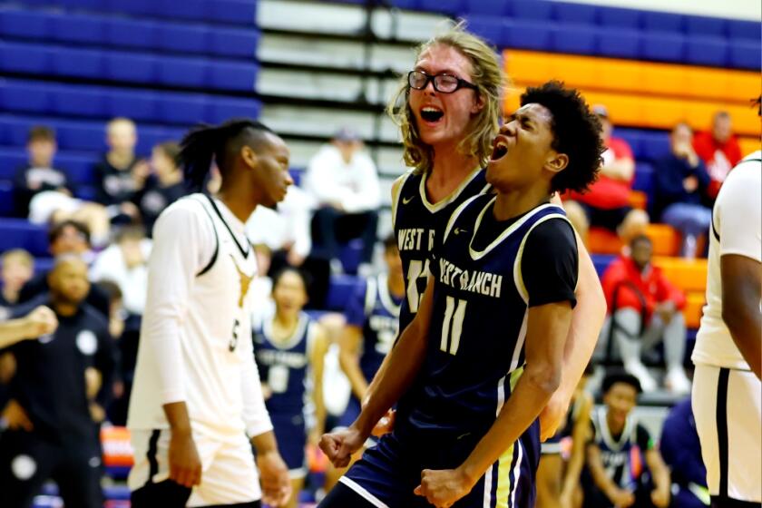 Darrell Morris (11) and Andrew Meadow take a moment to celebrate for unbeaten West Ranch.