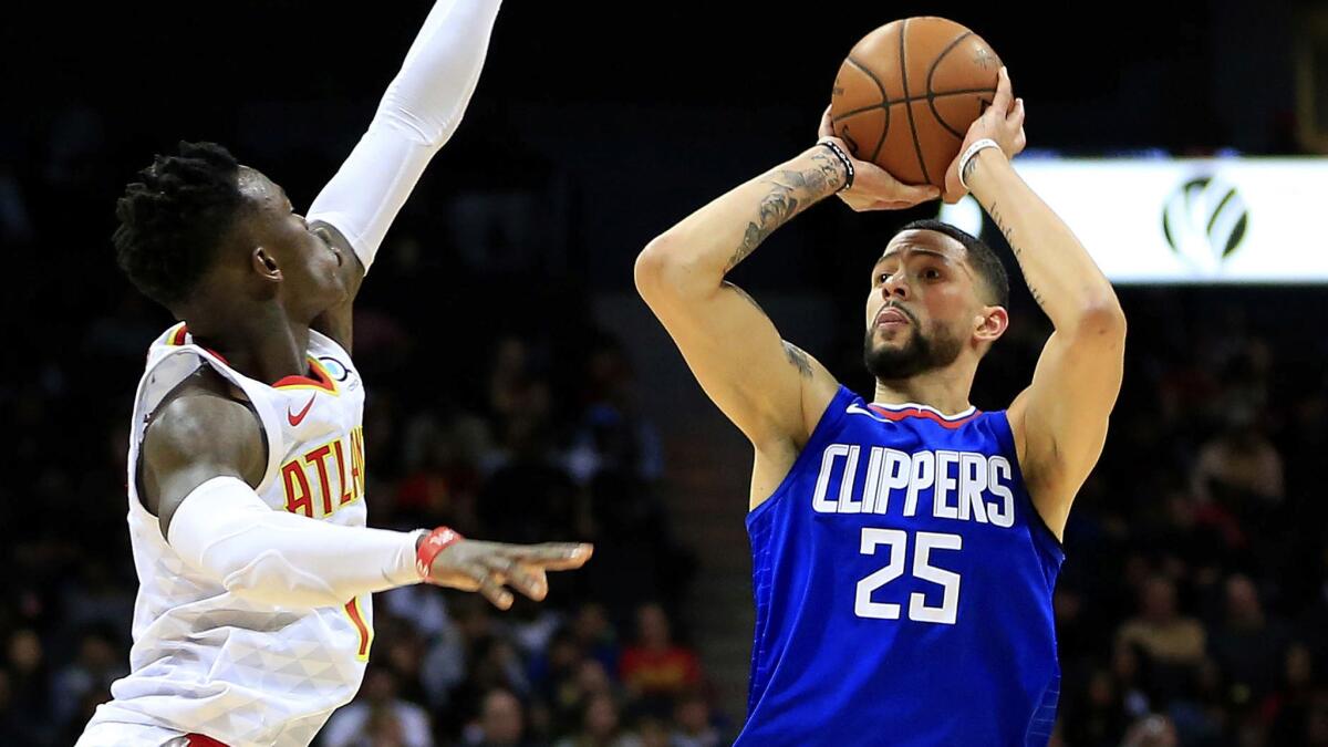 Clippers guard Austin Rivers shoots a three-pointer over Hawks guard Dennis Schroeder during the fourth quarter in Atlanta on Wednesday. (Daniel Shirey / Associated Press)
