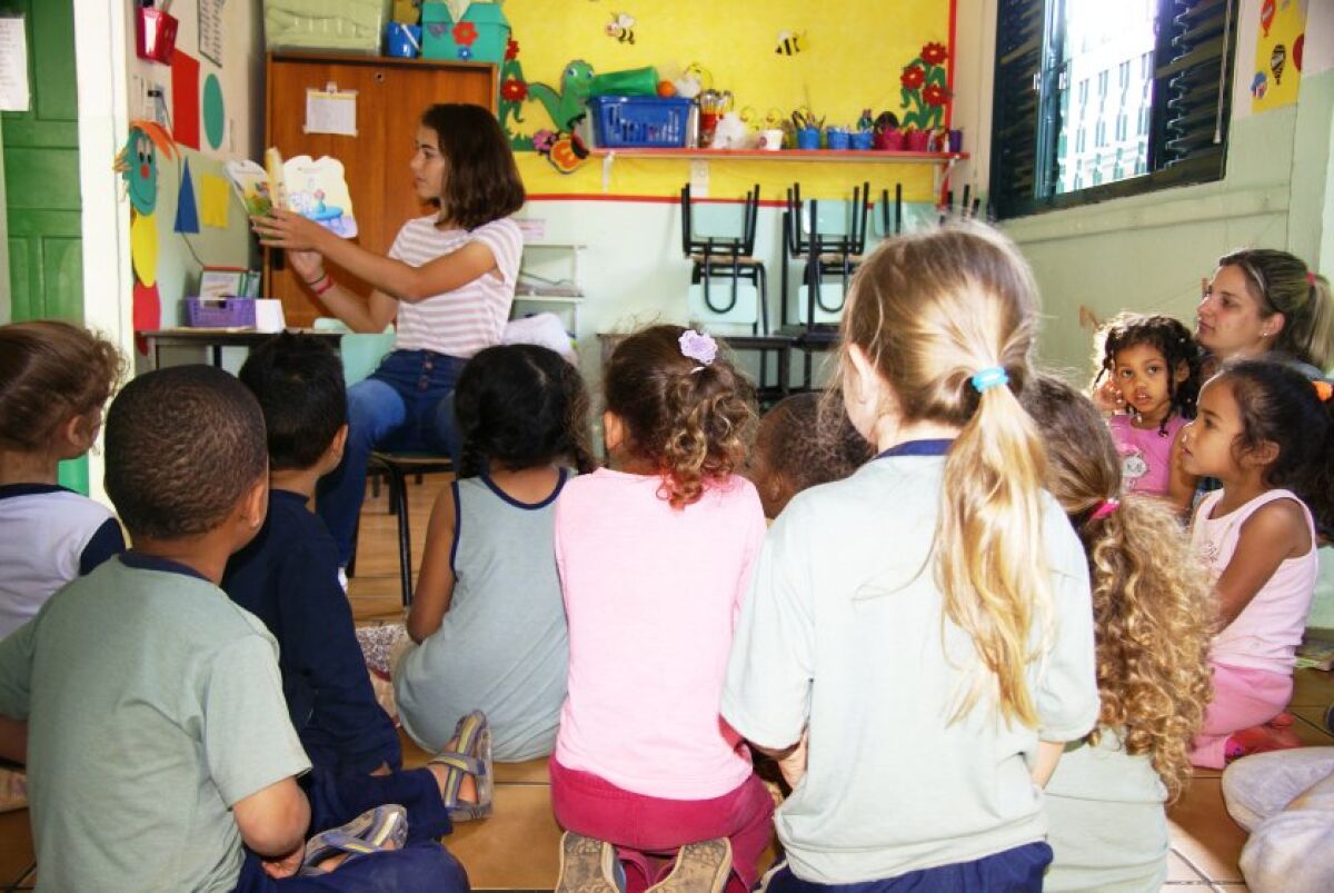 Beatriz De Oliveira, 17, of Carmel Valley, reads to a group of preschool students in her native Brazil. She runs Books for a Change, an organization that provides free books to underfunded preschools in Brazil.