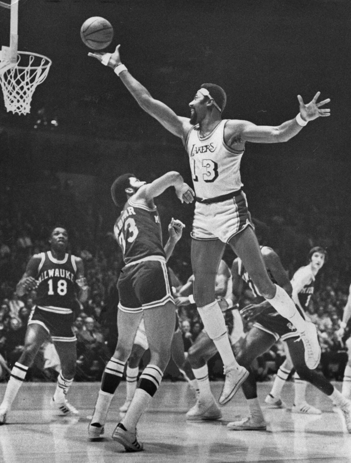 Lakers center Wilt Chamberlain elevates for a shot over Bucks center Kareem Abdul–Jabbar.