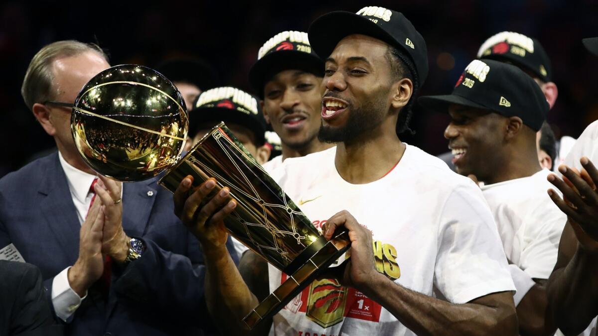 Toronto Raptors' Kawhi Leonard celebrates with the Larry O'Brien Championship Trophy after his team defeated the Golden State Warriors in Game 6 to close out the NBA Finals in Oakland on June 13.